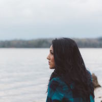 Woman looking into the distance by water