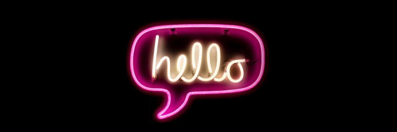 Responding to Strangers' Questions About My Wheelchair "Hello" speech bubble neon sign.