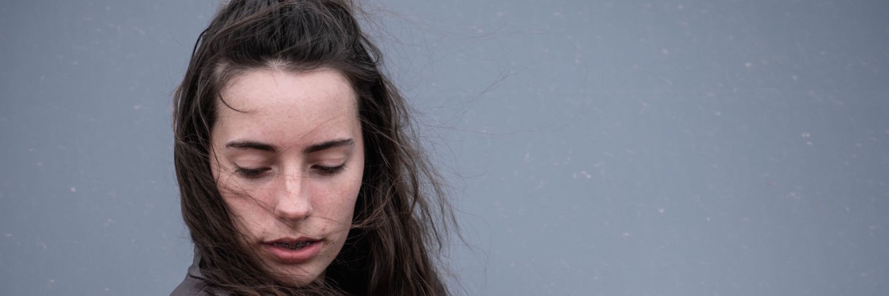 My Problem with Perfectionism Young woman with her arms around herself