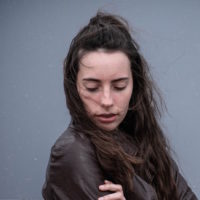 Young woman with her arms around herself
