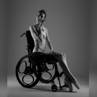 Kate Stanforth modeling, posing in her wheelchair.
