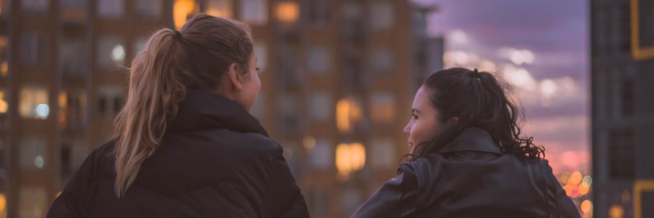 What to Know After Hidradenitis Suppurativa Diagnosis woman standing on city balcony