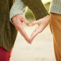 couple making a heart with each of their hands