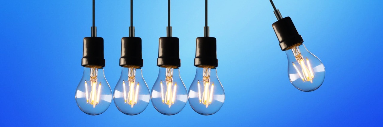 Launching a Community Think Tank for Neurological Conditions Group of hanging lightbulbs with one offset from the others.