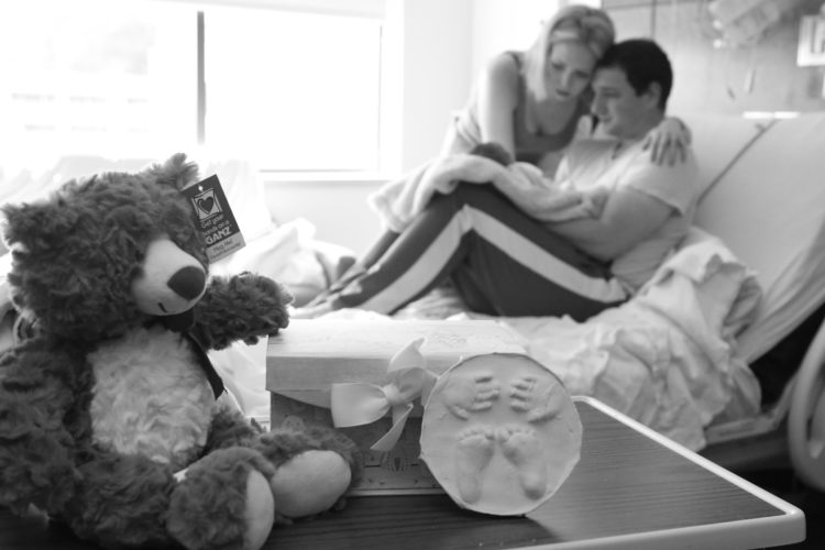 Parents in a hospital room with their newborn baby.