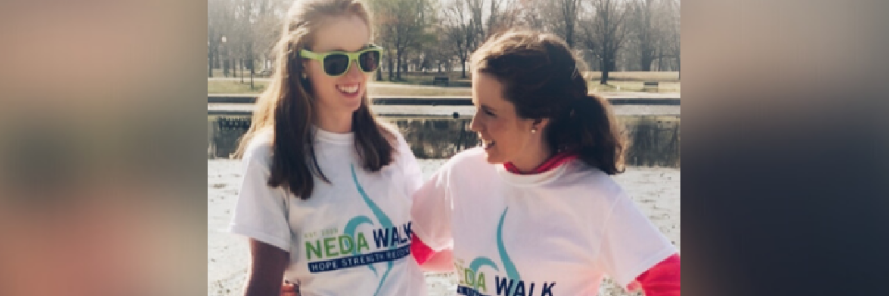 Two women smiling and wearing NEDA walk t-shirts