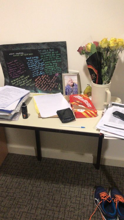photo of author's desk at the hospital with a chalkboard, pictures, and notebooks