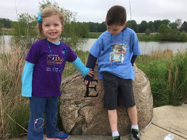 Little girl and her young brother are holding hands