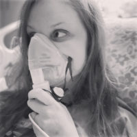 Cheyanne using a nebulizer mask.