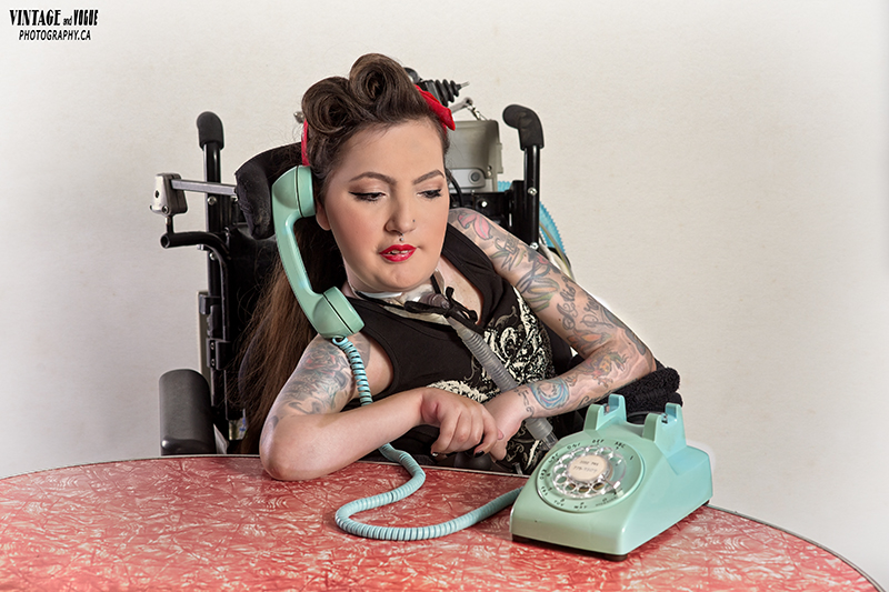 Crystal in retro pin-up attire using a teal vintage phone.