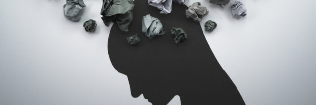 a silhouette of a man with paper over his head