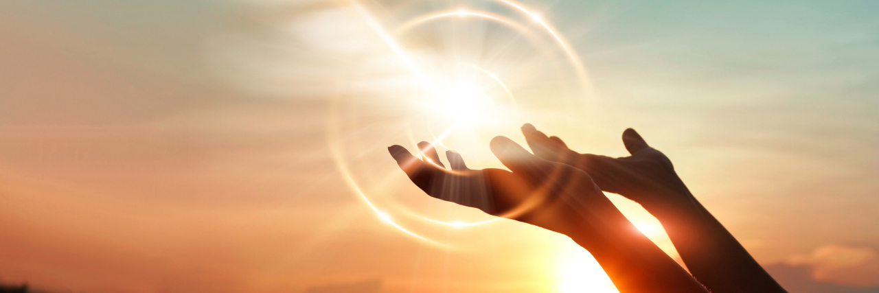 ‘Living Life to the Fullest’ With Terminal Ovarian Cancer Woman hands raised towards sky, sunset in background