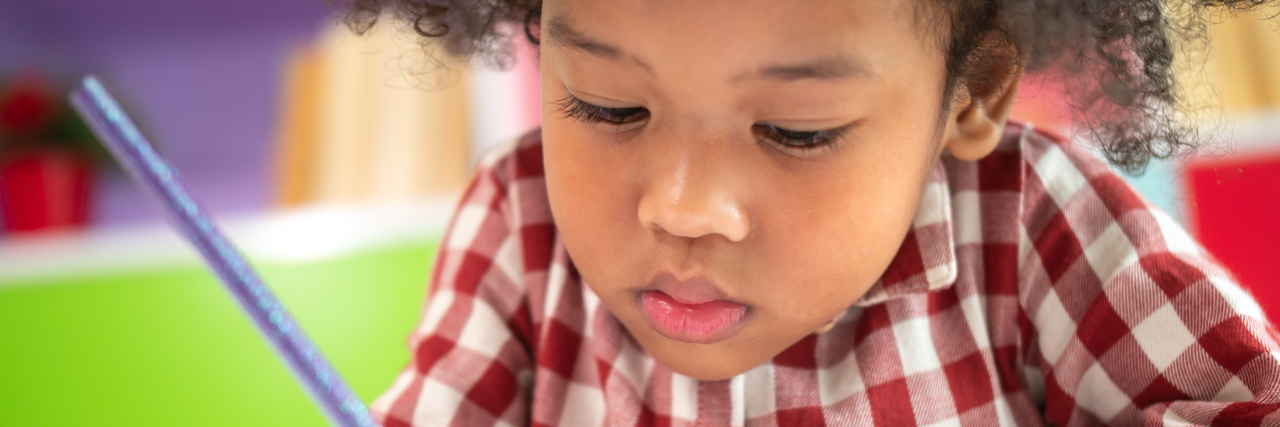 Rethinking Homework for Students With Disabilities African-American girl doing homework.