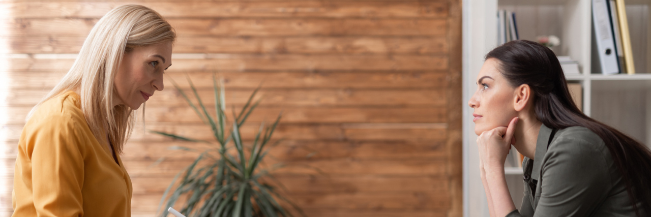 Are You Missing Out On the Benefits of Counseling? Low angle of psychologist taking notes on clipboard while sitting opposite the client. Patient is listening attentively to a doctor while sitting in armchair. Concept of psychology support