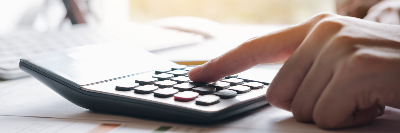 Why Using a Calculator Does Not Help My Math Disability Woman using calculator.