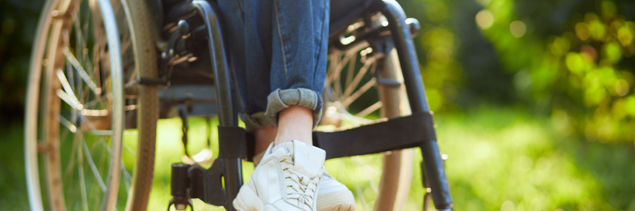 The Good and Bad Sides of Navigating Life in a Wheelchair Young disabled woman in wheelchair sitting with crossed legs.