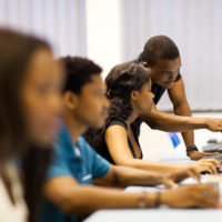 african american college students sitting in a computer room