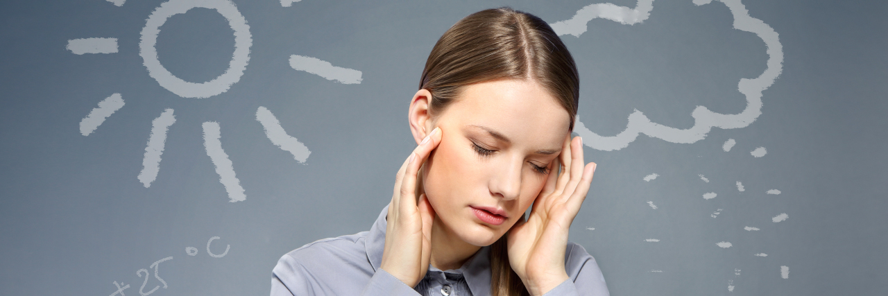 5 Tips for Managing Barometric Pressure or Weather-Related Migraine Attacks Woman having a headache. Weather concept.