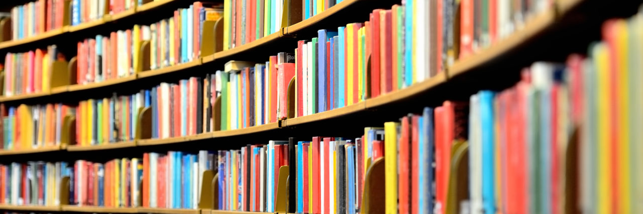 Getting Disability Accommodations for ADHD at University Round bookshelf in university library.