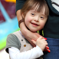 Mother hugging her daughter with Down syndrome.