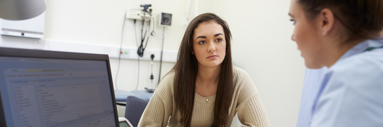 What Happened When I Requested My Medical History a woman and a nurse sitting at a computer in a doctor's office
