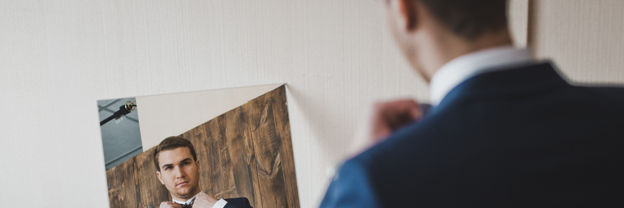 What You Should Know About Body Dysmorphia in Men The man looks in the mirror.