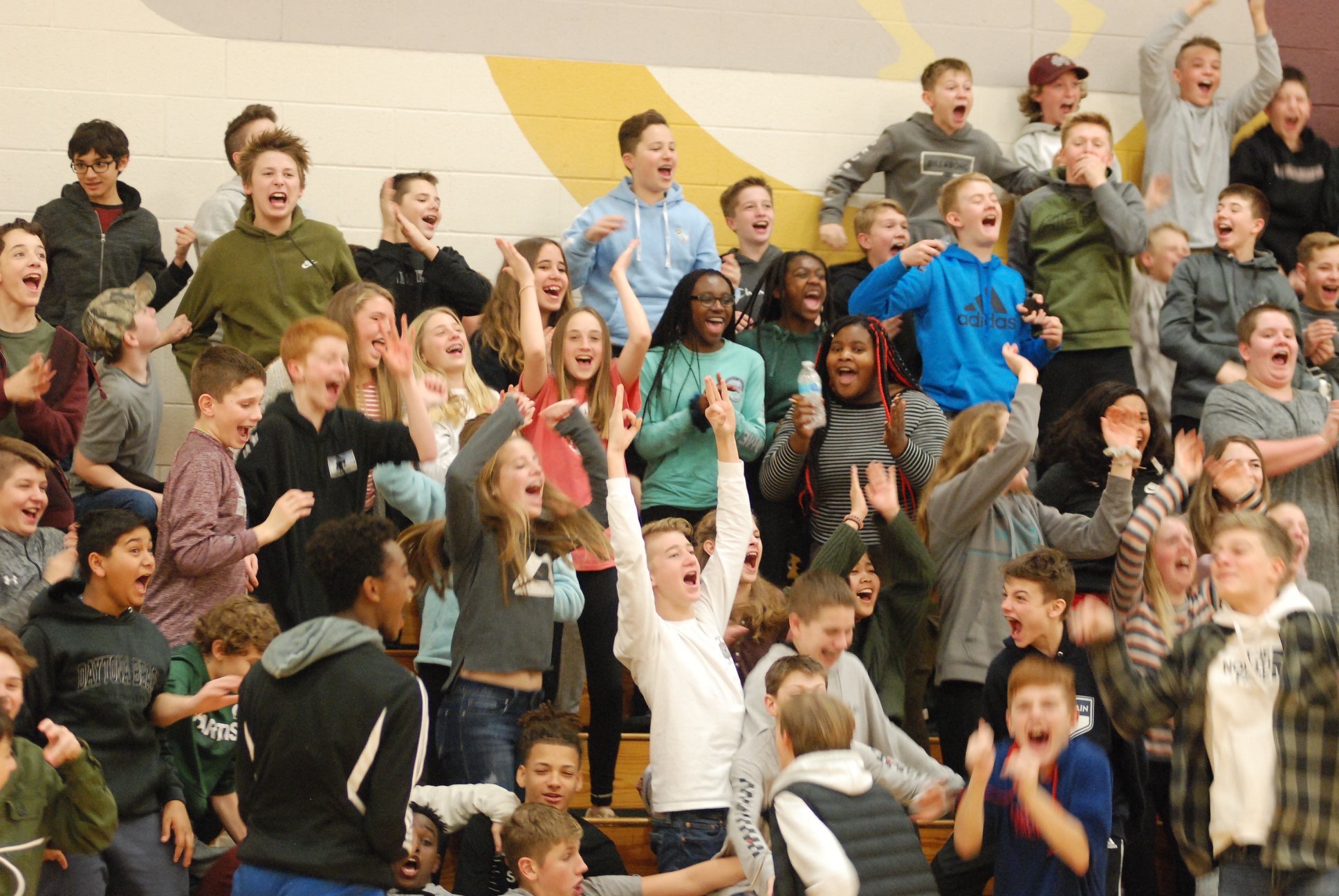 Spectators cheer at a Unified Sports basketball game.