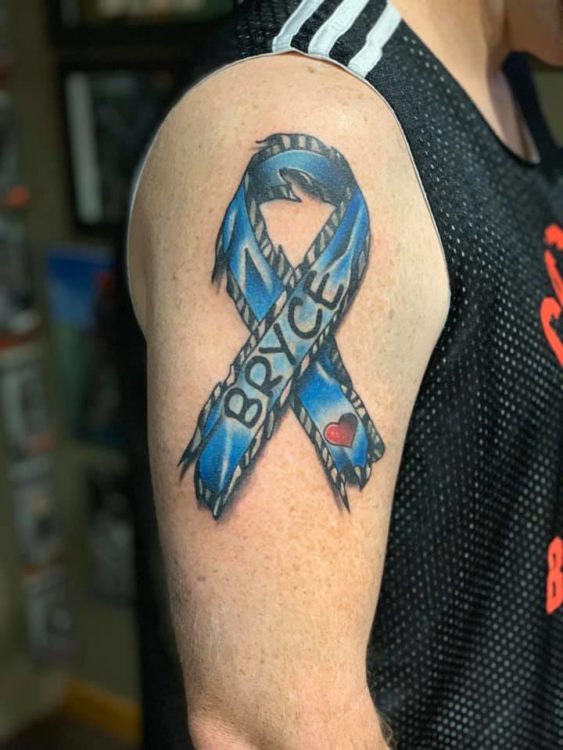 a blue ribbon tattoo with the words "bryce"
