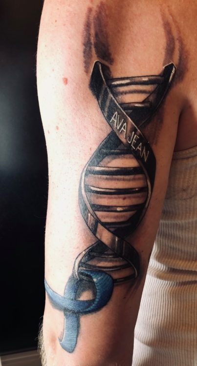 tattoo of DNA rung and a ribbon
