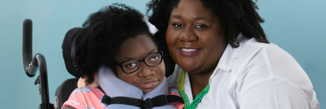 Why Parenting a Child With a Disability Makes Me Think About Death A mother is taking a picture with her daughter who uses a wheelchair.