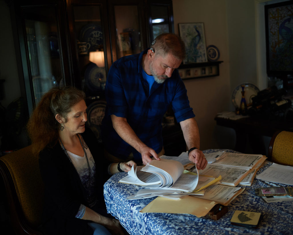 Darla Markley and her husband, Andy Markley, review their medical paperwork. Even after Mayo wrote off some of what they owed, Darla’s disability and Social Security checks barely covered her insurance premiums. By 2014, five years after her initial hospitalization, they had no choice but to declare bankruptcy.