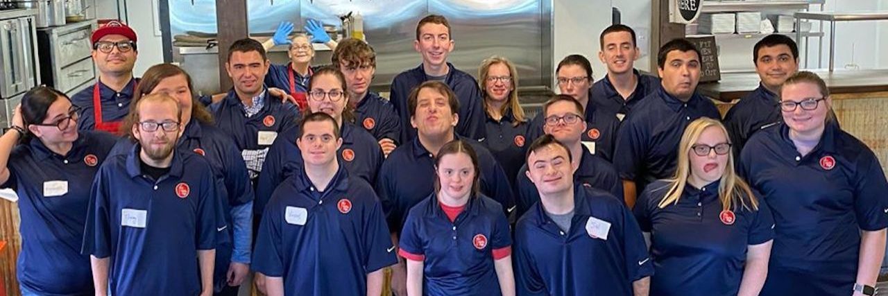 New Cafe Hiring People With Disabilities Opens in New Jersey No Limits Cafe staff, about 30 people in a group wearing blue polo shirts