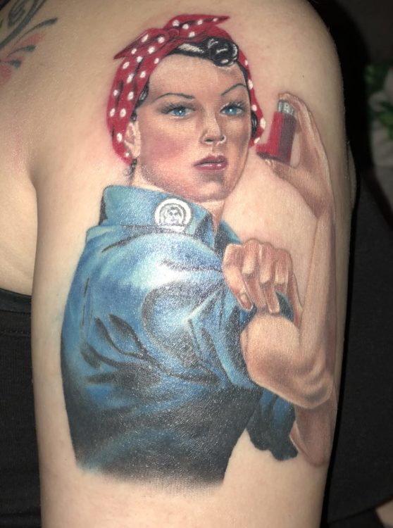 tattoo of Rosie the Riveter like character flexing her arm