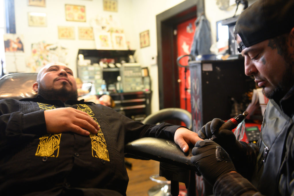 After losing part of two fingers in a work accident 16 years ago, José Alvarado receives two fingernail tattoos at Eternal Ink Tattoo Studio on Nov. 20, 2019, in Hecker, Ill. (Michael B. Thomas for KHN)