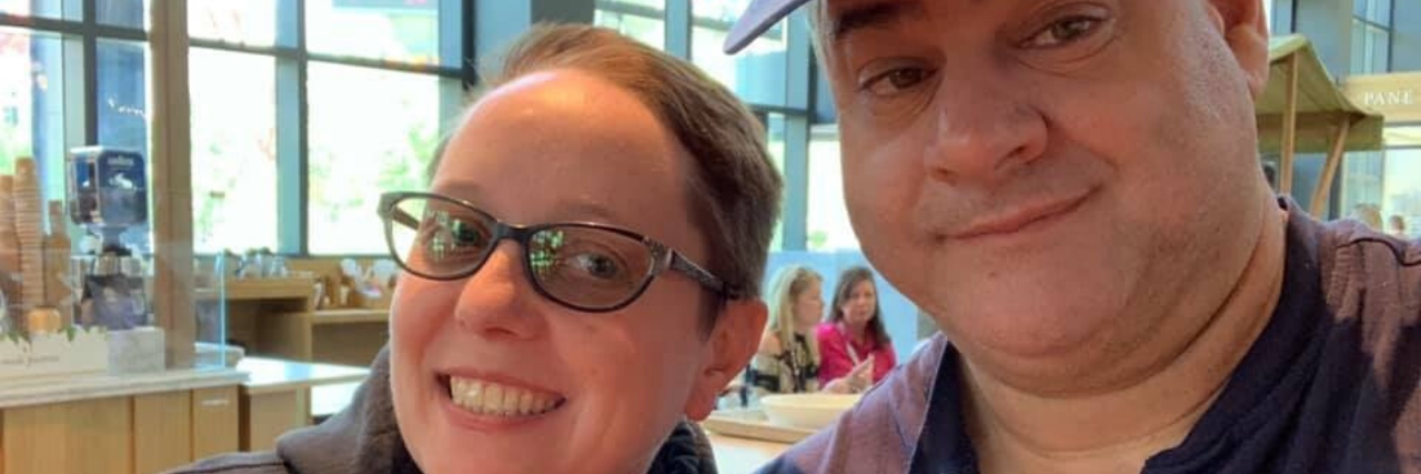 What to Know If Your Partner Has Uncovered Childhood Sexual Abuse photo of woman and husband posing and smiling for camera and holding drinks