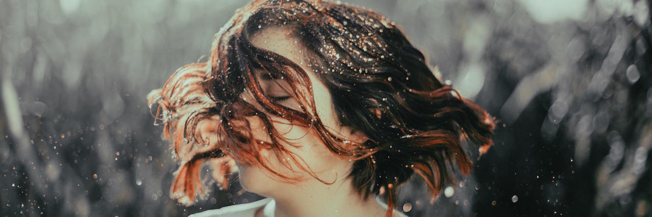 Creating Boundaries in My Relationships as an Abuse Survivor Woman shaking her head during a rainstorm