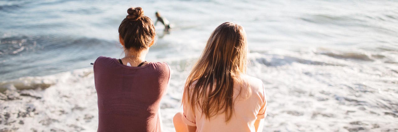 A Letter From Your Friend With Depression Two young women sit looking out over the ocean