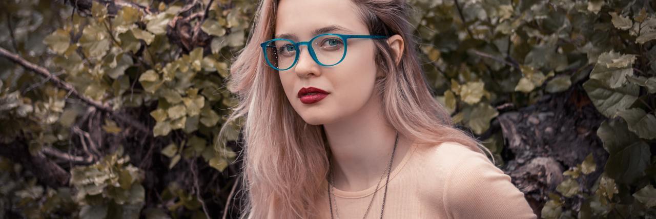 photo of blonde woman with glasses looking into camera with angry expression
