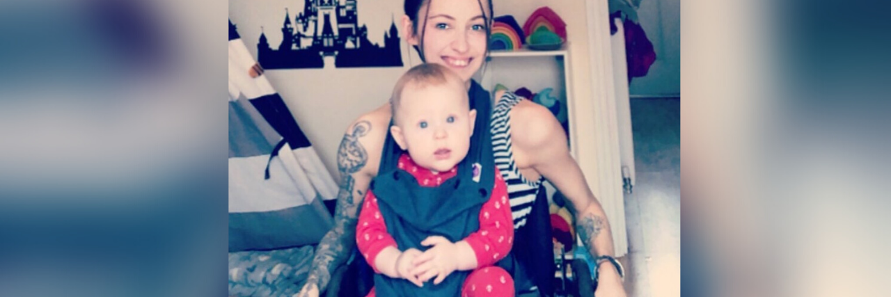 Learning to Love Myself as a Disabled Person in an Ableist World Molly sitting in her wheelchair with her son on her lap.