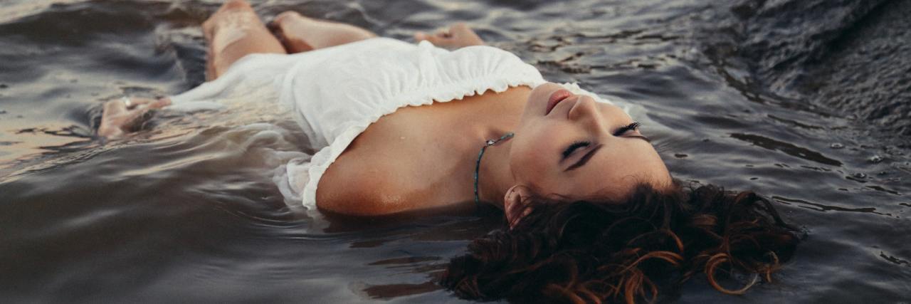 To People Fighting Chronic Illness, It's OK to Say 'I'm Tired' woman lying in water floating on her back