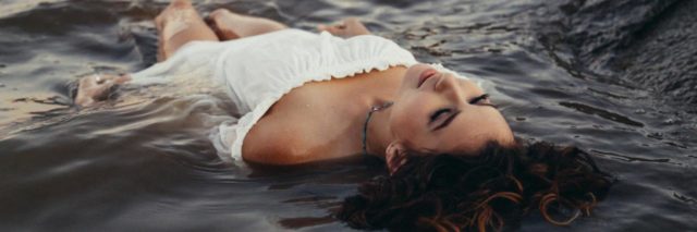 woman lying in water floating on her back