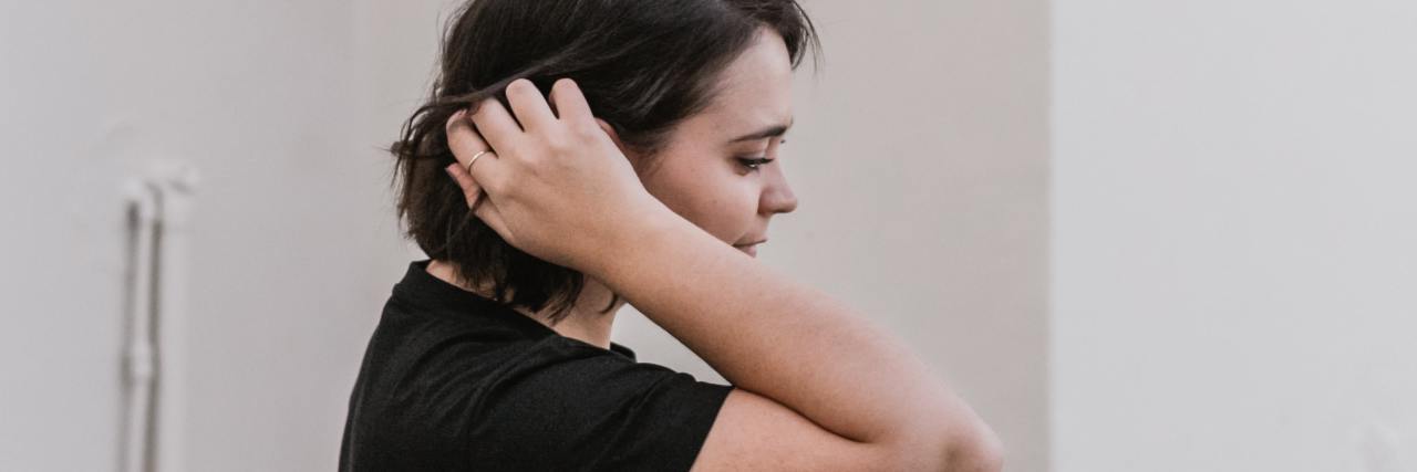 photo of plus-size woman with hand in her hair and eyes closed