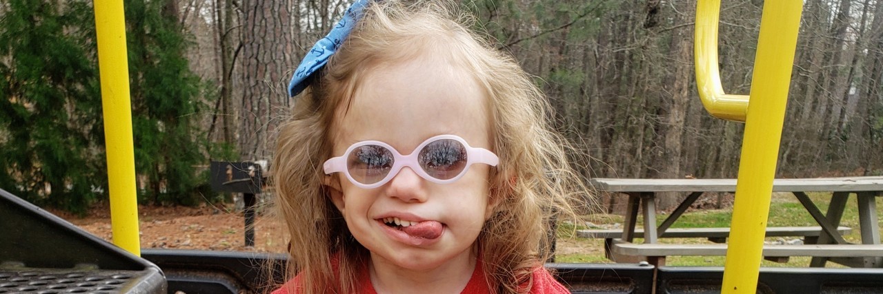 Protecting My Medically Fragile Child From the Coronavirus Kimberly's daughter who has trisomy 18 on the playground. She is medically fragile and in danger due to the COVID-19 coronavirus.