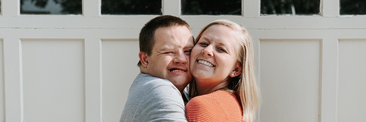 Erin hugging her brother who has Down syndrome.