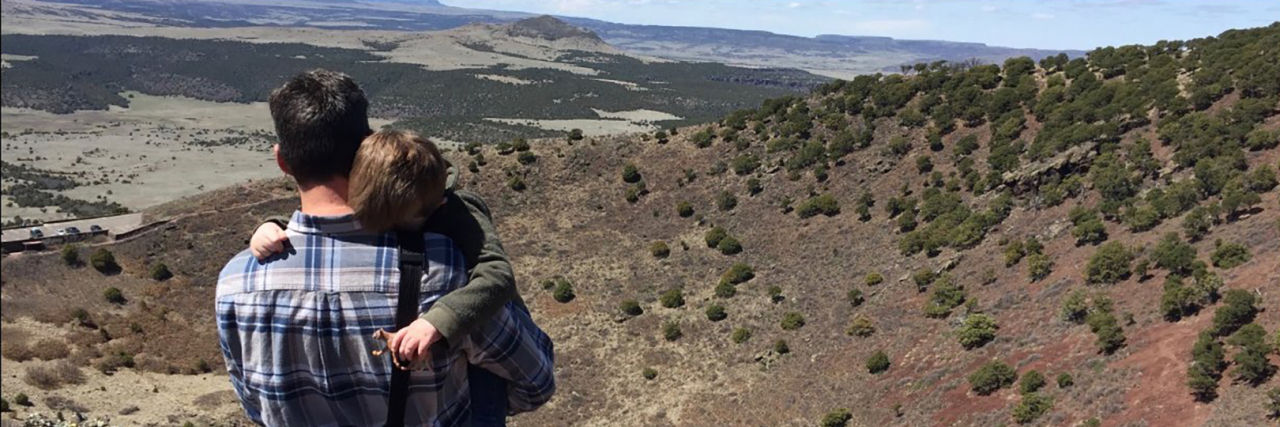 Teaching Your Child With AAC Device During Coronavirus Pandemic Parent holding child in the desert.