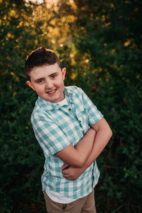 The author's son, a 10-year-old standing with his arms crossed 