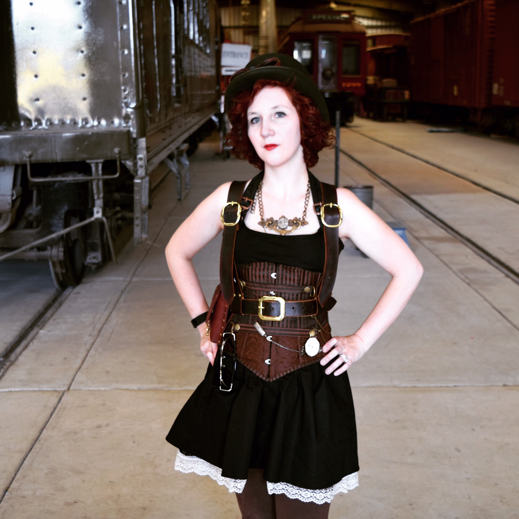 Amelia wearing a simple black dress with steampunk corset.