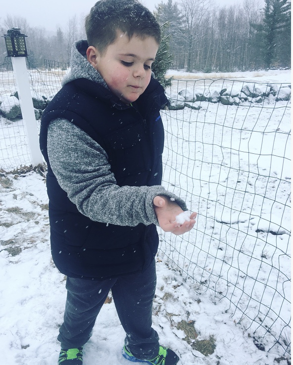 Young boy holding a snow ball
