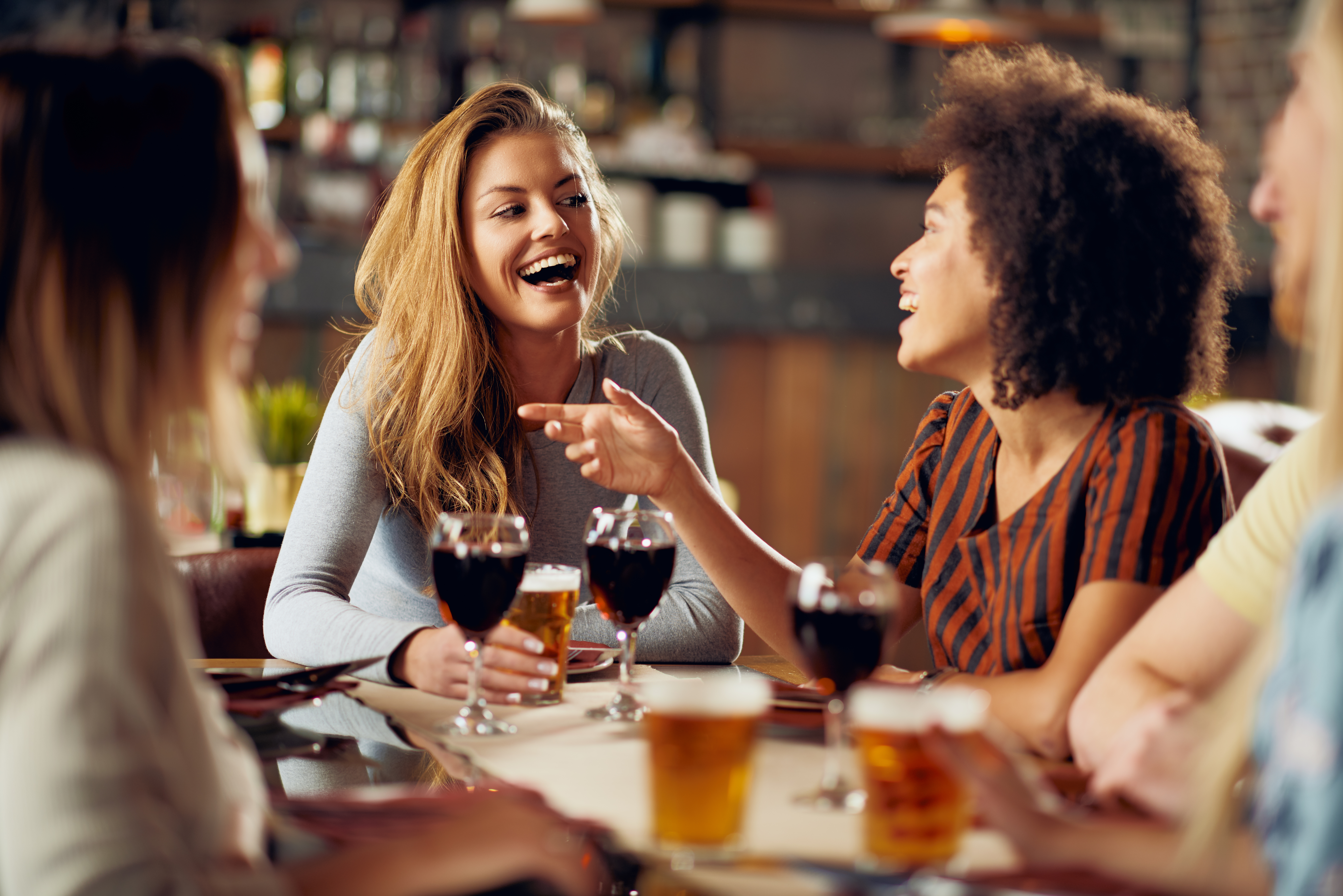 Friends laughing in a restaurant.