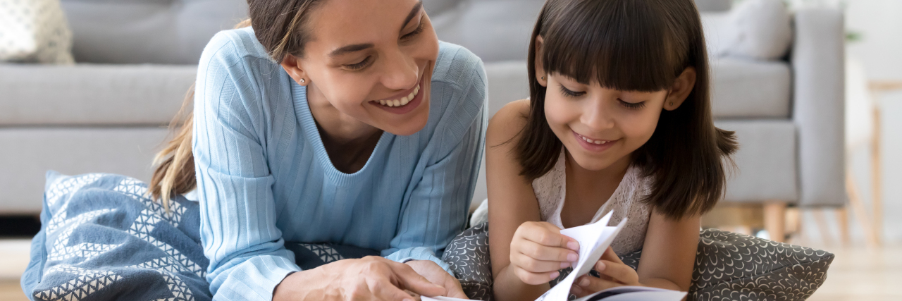 Support for Moms With an Invisible Disability Mother reading book with young daughter.